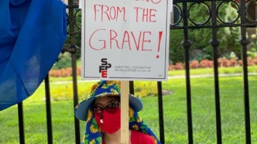 We are not teaching from the grave (sign a protestor is holding)