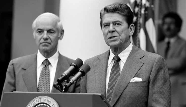 President Reagan with William French Smith making a statement to the press regarding the air traffic controllers strike (PATCO) from the Rose Garden on August 3, 1981.